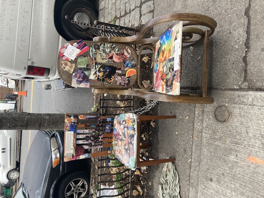 Chairs in front of apartment building with families